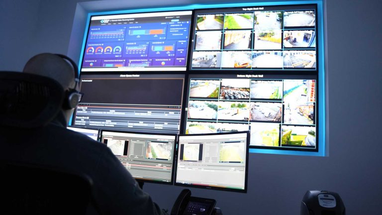 a cctv control room operative monitoring cctv cameras at a remote video receiving centre